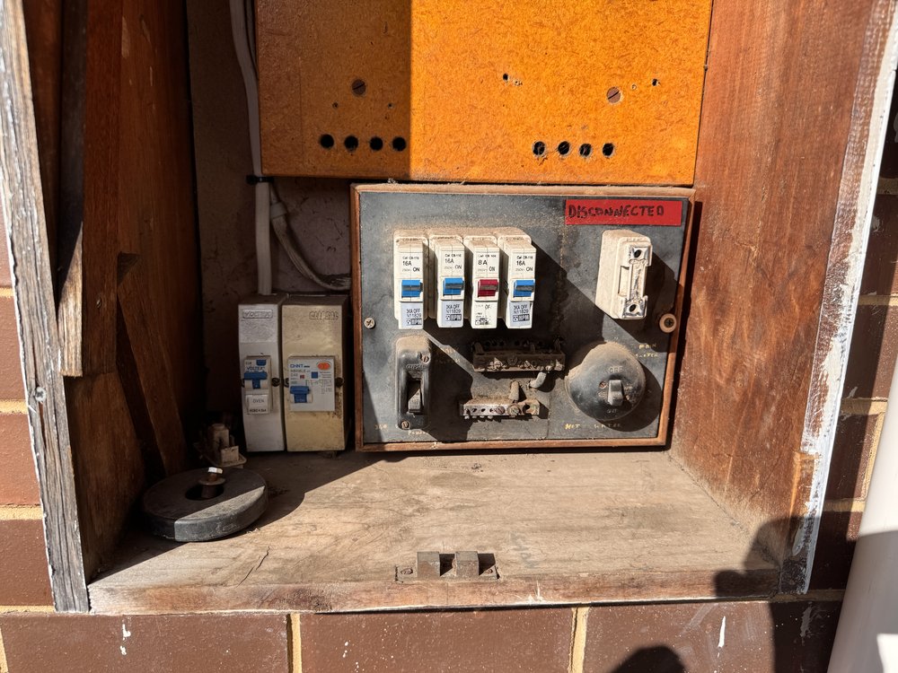 Old ceramic fuse board, disconnected, before upgrade